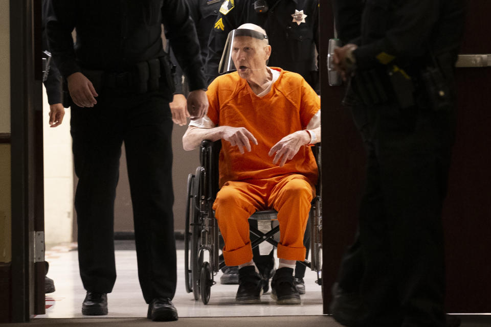 Sacramento County Sheriff's Deputies use a wheelchair to bring Joseph James DeAngelo into the courtroom in Sacramento Superior Court in Sacramento, Calif. Monday, June 29, 2020. DeAngelo, 74, pleaded guilty to 13 counts of murder and multiple other charges 40 years after a sadistic series of assaults and slayings in California. Due to the large numbers of people attending, the hearing was held at a ballroom at California State University, Sacramento to allow for social distancing. (AP Photo/Rich Pedroncelli)