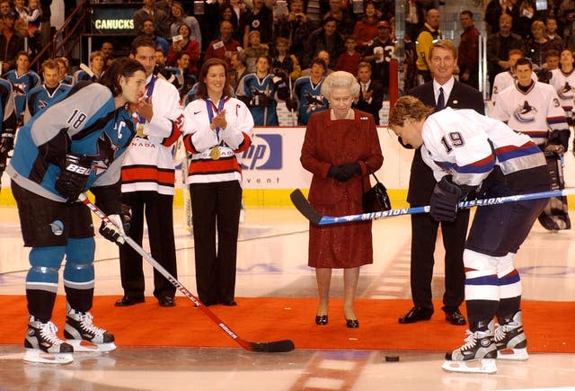 Queen Elizabeth II starts an ice hockey game between San Jose Sharks and Vancouver Canucks  during her two-week Golden Jubilee tour of Canada