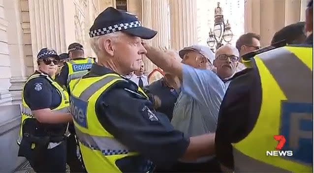 Angry taxi drivers and owners pushed into officers. Picture: 7 News