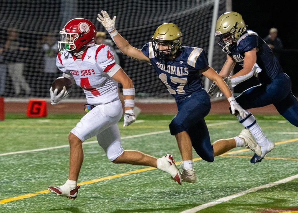 Daniel Wing of St. John's runs for a touchdown in the fourth quarter past Shrewsbury's Tyler Boehnke Friday.