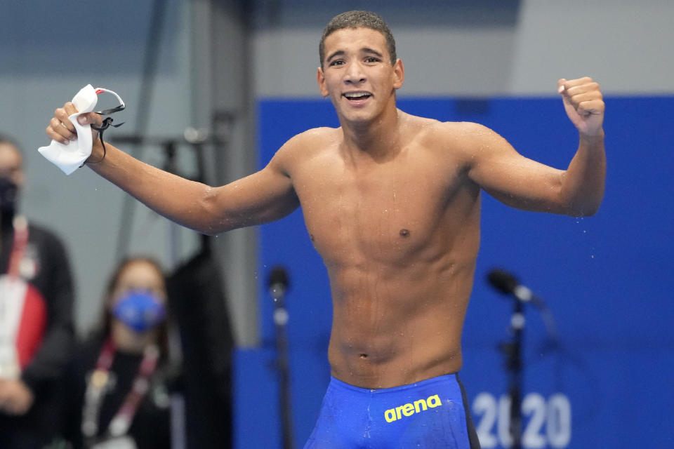 Ahmed Hafnaoui, of Tunisia, celebrates after winning the final of the men's 400-meter freestyle at the 2020 Summer Olympics, Sunday, July 25, 2021, in Tokyo, Japan. (AP Photo/Martin Meissner)