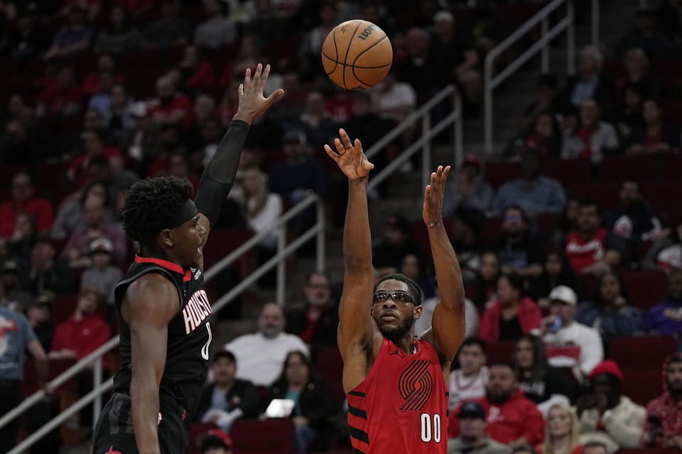 Portland Trail Blazers guard Scoot Henderson (00) misses a shot against Houston Rockets guard Aaron Holiday during the first half of an NBA basketball game Wednesday, Jan. 24, 2024, in Houston. (AP Photo/Kevin M. Cox)