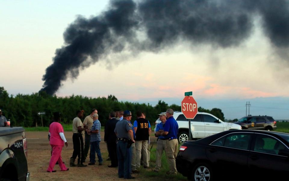 Emergency officials respond to the site of a military plane crash  - Credit: Elijah Baylis/The Clarion-Ledger/AP
