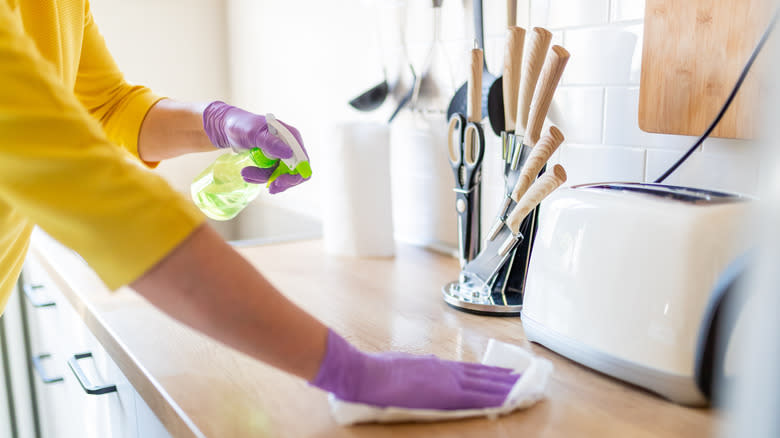 Woman spraying counter