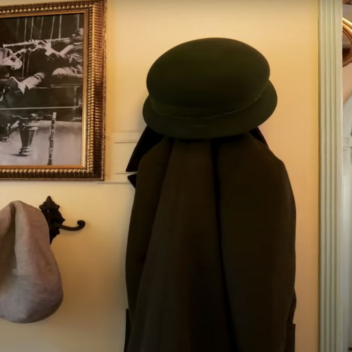 Hats and coat hanging on a wall
