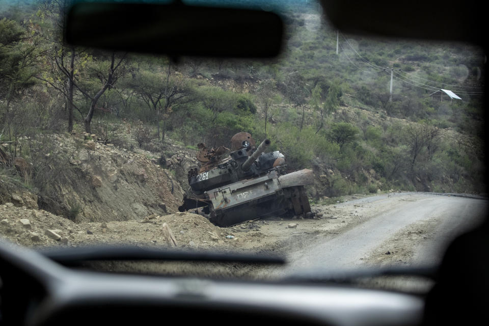 A destroyed tank sits by the side of a road leading to Abi Adi, in the Tigray region of northern Ethiopia, on Tuesday, May 11, 2021. The Tigray People’s Liberation Front was on top of a coalition that ruled Ethiopia for nearly three decades. That changed in 2018, when Prime Minister Abiy Ahmed rose to power as a reformist. Abiy alienated the TPLF with efforts to make peace with its archenemy, Eritrea, and rid the federal government of corruption. (AP Photo/Ben Curtis)