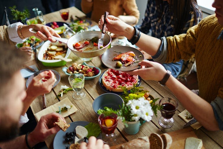 A family eating a buffet lunch.