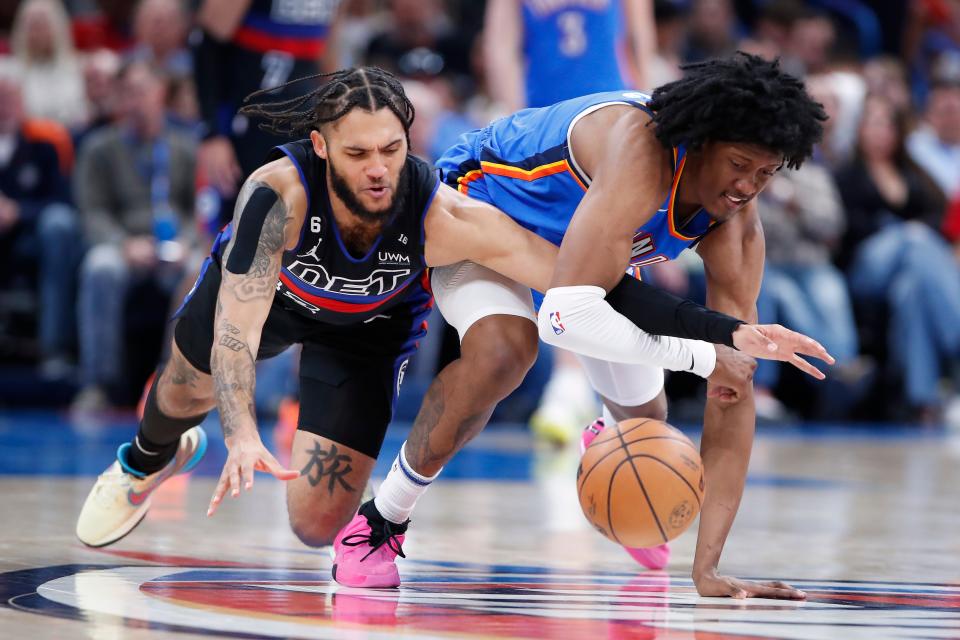 Detroit Pistons forward Isaiah Livers (12) and Oklahoma City Thunder forward Jalen Williams (8) drive for a loose ball during the second quarter at Paycom Center in Oklahoma City on Wednesday, March 29, 2023.
