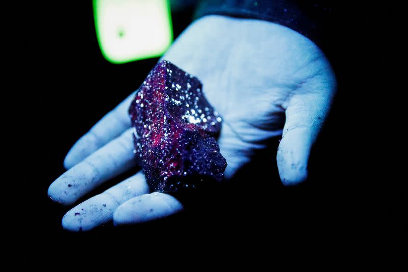 Tungsten is illuminated with mineral light in a mine in Gangwon Province