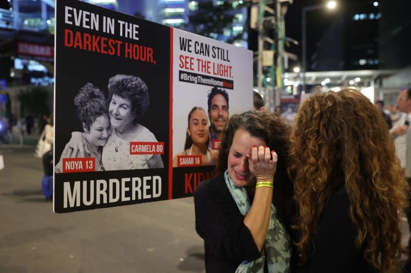 Outside the Kirya military base in Tel Aviv on Tuesday, Hadas Kalderon (C), the mother of Israeli hostage Sahar and her husband, Ofer Kalderon, cries during a protest that called on the government to sign an agreement with Hamas for a release of hostages. Israeli Prime Minister Benjamin Netanyahu has convened his war cabinet to approve a deal for the release of hostages. Photo by Abir Sultan/EPA-EFE