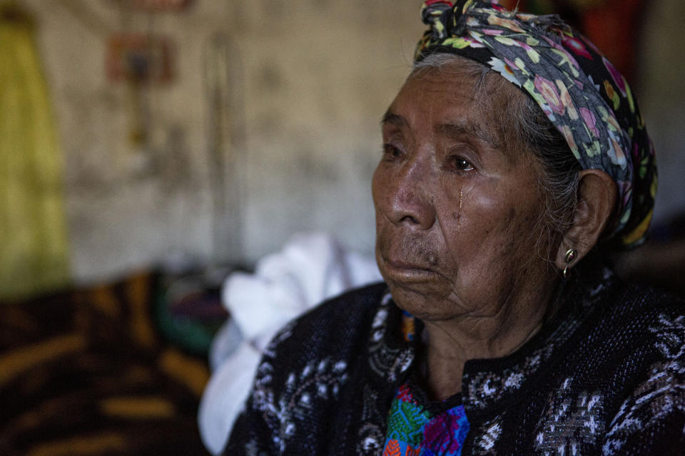 Valentina Ramirez cries as she hears a relative interviewed about the fate of her neighbor Rivaldo Jimenez, in Comitancillo, Guatemala, Wednesday, Jan. 27, 2021. Jimenez family members believe he may be one of the charred corpses found in a northern Mexico border state on Saturday. The country's Foreign Ministry said it was collecting DNA samples from a dozen relatives to see if there was a match with any of the bodies. (AP Photo/Oliver de Ros)