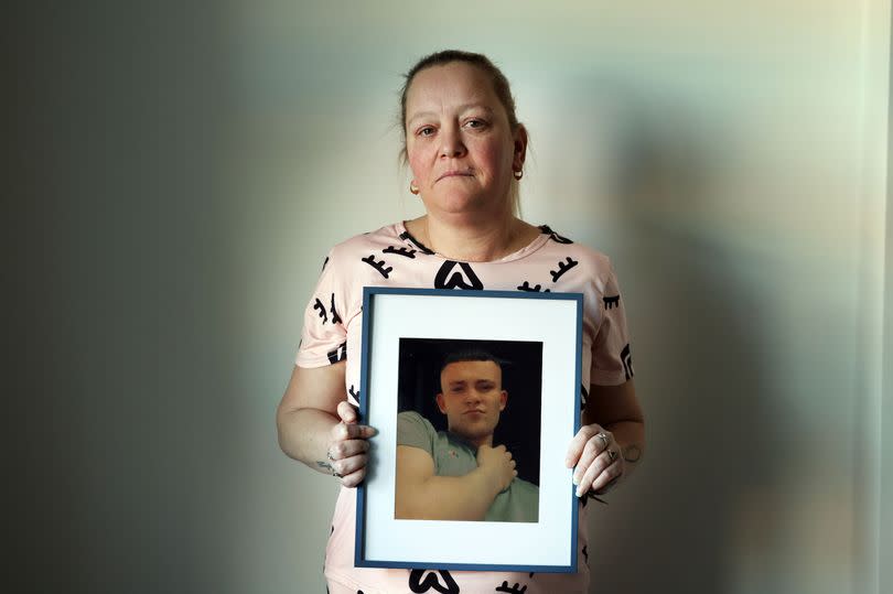 Julie Weatherson holding a photo of son Bradley Tams