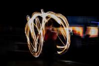 A ski instructor at Afriski in Lesotho swirls fire ahead of a torchlight procession from the top of the main slope