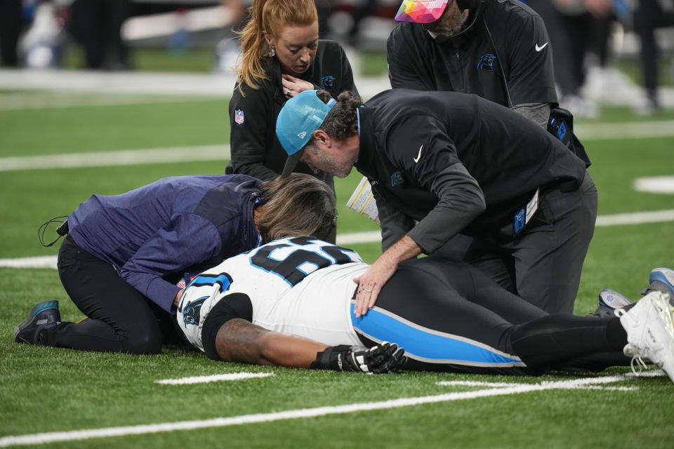 Carolina Panthers guard Chandler Zavala (62) is tended to after being injured in the first half of an NFL football game against the Detroit Lions in Detroit, Sunday, Oct. 8, 2023. (AP Photo/Carlos Osorio)