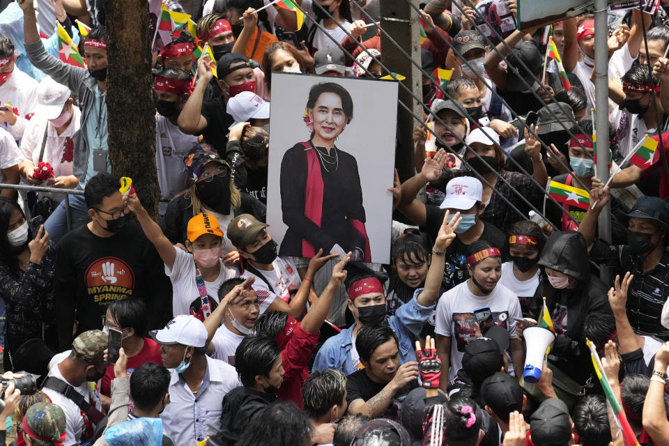Myanmar nationals living in Thailand hold a picture of deposed Myanmar leader Aung San Suu Kyi as they protest outside Myanmar's embassy in Bangkok, Thailand, Tuesday, July 26, 2022. International outrage over Myanmar’s execution of four political prisoners is intensifying with grassroots protests and strong condemnation from world governments. (AP Photo/Sakchai Lalit)