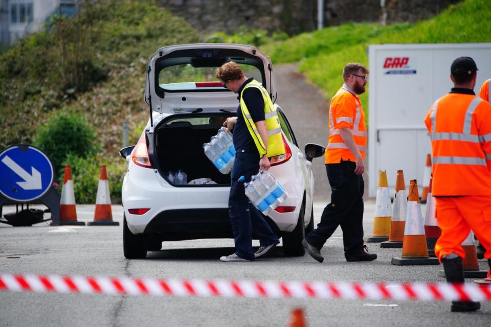 Bottled water being given out after an outbreak of cryptosporidium in Brixham (PA Wire)