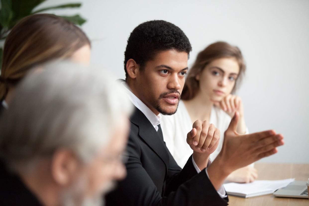 man in meeting with serious expression