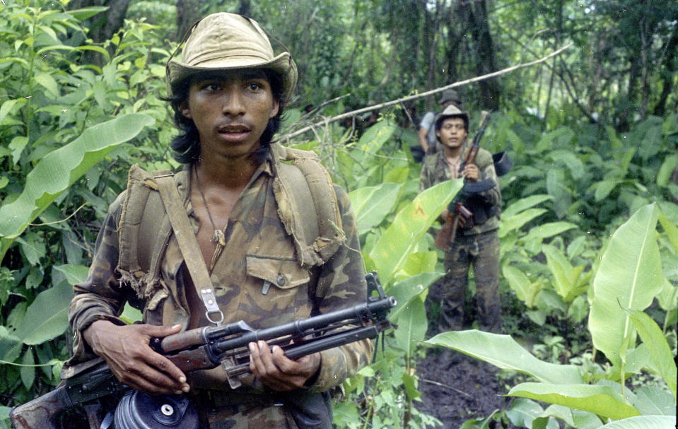 FILE - In this Aug. 1986, file photo, a Sandinista soldier walks warily through the jungle on a patrol to hunt U.S.-backed contra rebels near Zompopera in northern Nicaragua. There is increasing concern for the safety of journalists covering protests at state capitals across the U.S., and in Washington. Packing a gas mask and helmet has become the new normal. It's starting to look, just a bit, like what foreign correspondents face in the world's conflict zones. (AP Photo/Andrew Selsky, File)