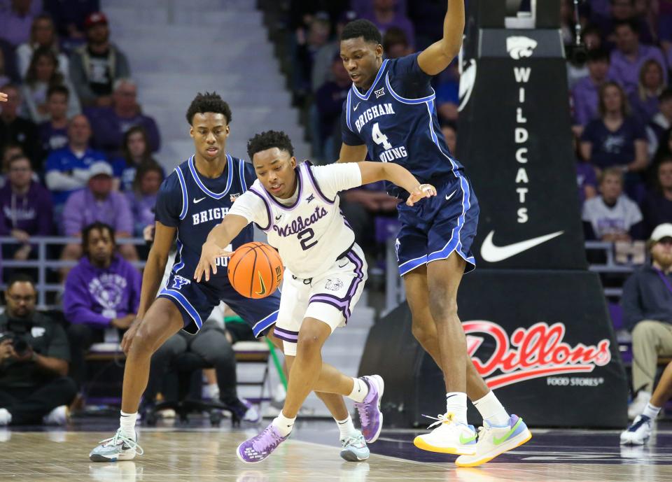 Kansas State guard Tylor Perry (2) loses the ball while guarded by BYU's Atiki Ally Atiki (4) during their game Saturday at Bramlage Coliseum.