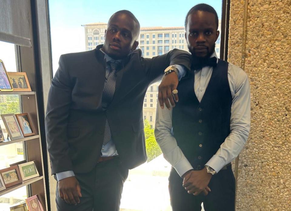 Emmanuel Jean, left, and his brother Nahum Jean, right, pose for a photo in May 2023 at Joe Klock’s law office in Coral Gables. Jean was released from prison 16 years after being wrongfully accused.