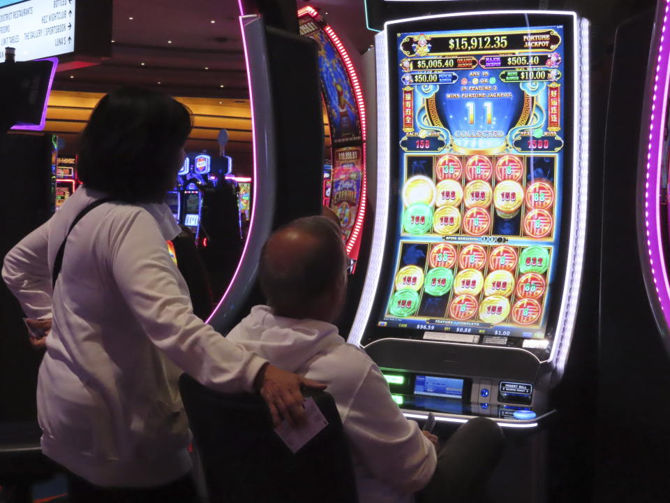 A gambler plays a slot machine at the Ocean Casino Resort in Atlantic City, N.J. on Nov. 29, 2023. Internet gambling and sports betting both set new records in November as gamblers continue to take advantage of more options in addition to traveling to physical casinos in order to wager. (AP Photo/Wayne Parry)