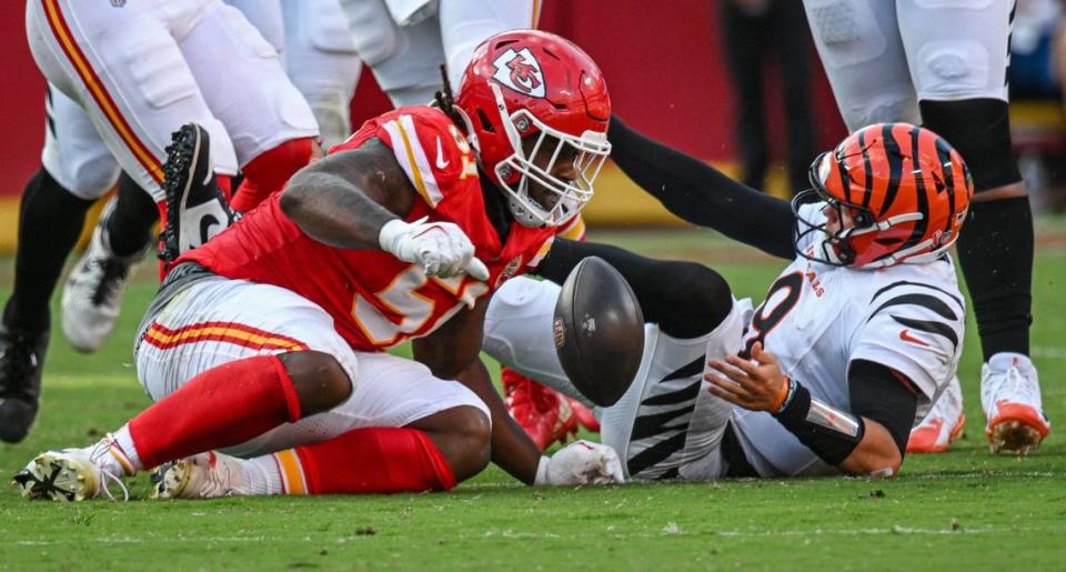 Cincinnati Bengals quarterback Joe Burrow (9) fumbles the ball after being hit by Kansas City Chiefs defensive end Mike Danna (51) and defensive tackle Tershawn Wharton [98] in the second half Sunday, Sept. 15, 2024, at GEHA Field at Arrowhead Stadium. The ball was picked up by Kansas City Chiefs safety Chamarri Conner (27) who ran it in for a touchdown.