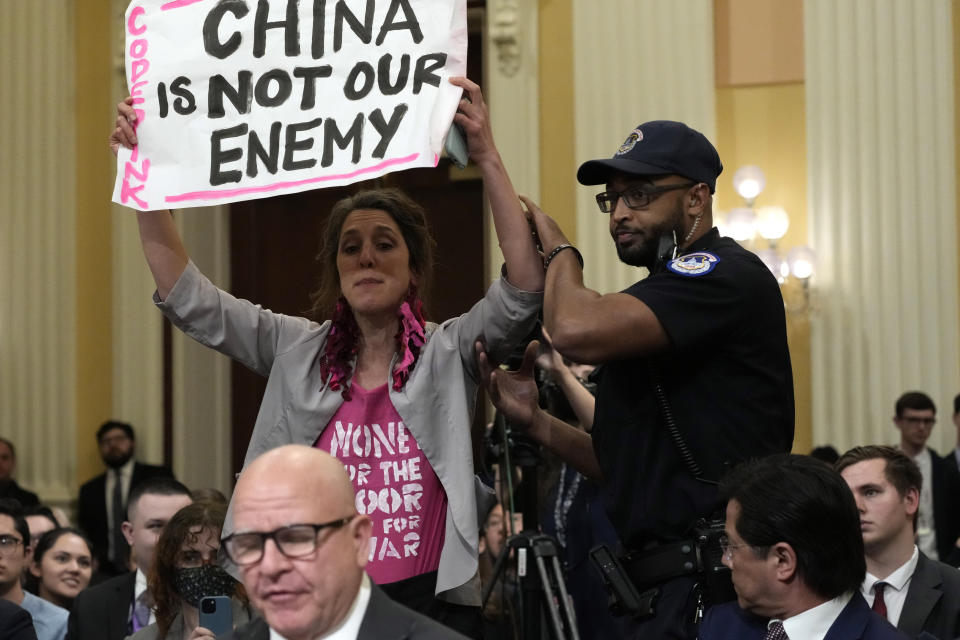 A protester holds a sign that reads: China is not our enemy.