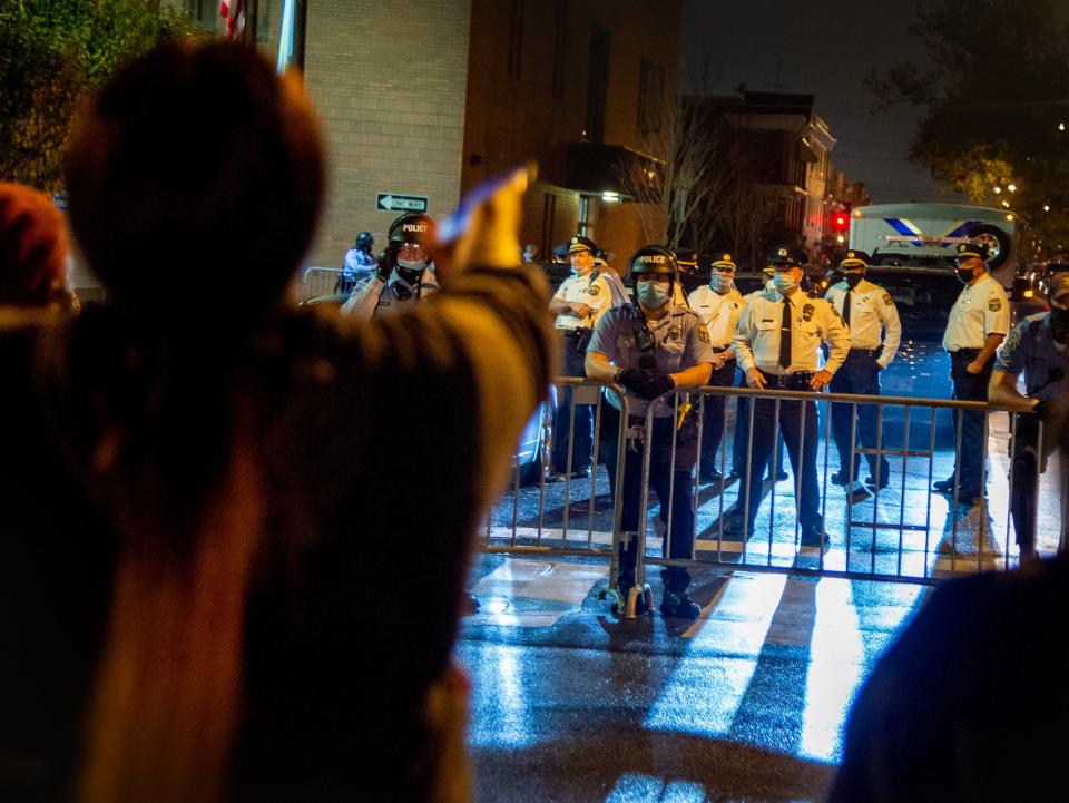 Neighbourhood residents shout at police outside the 18th District police station Monday night on 26 October 2020, in Philadelphia ((Associated Press))