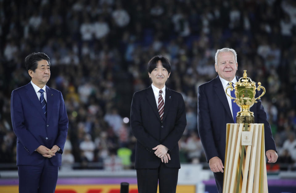 Japan's Prime Minister Shinzo Abe, Japan's Crown Prince Akishino and World Rugby chairman Bill Beaumont, from left, during the presentation ceremony after the Rugby World Cup final at International Yokohama Stadium between England and South Africa in Yokohama, Japan, Saturday, Nov. 2, 2019. (AP Photo/Christophe Ena)