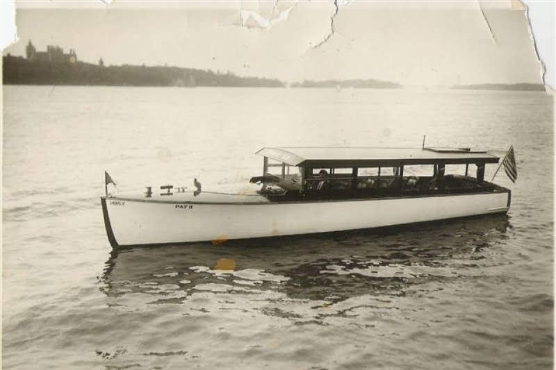 (Courtesy: Finger Lakes Boating Museum) The Pat II on the St Lawrence River mid 1920s with Boldt Castle in background