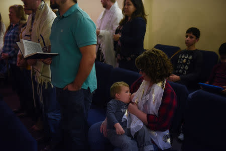 Lauren Hoffmann, 29, a college program manager, nurses her two-year old son Asa during a Shabbat service in San Antonio, Texas, U.S., February 22, 2019. REUTERS/Callaghan O'Hare