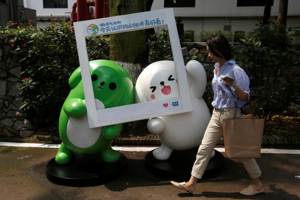 A girl walks past WeChat mascots inside TIT Creativity Industry Zone where Tencent office is located in Guangzhou, China May 9, 2017. Picture taken May 9, 2017. REUTERS/Bobby Yip