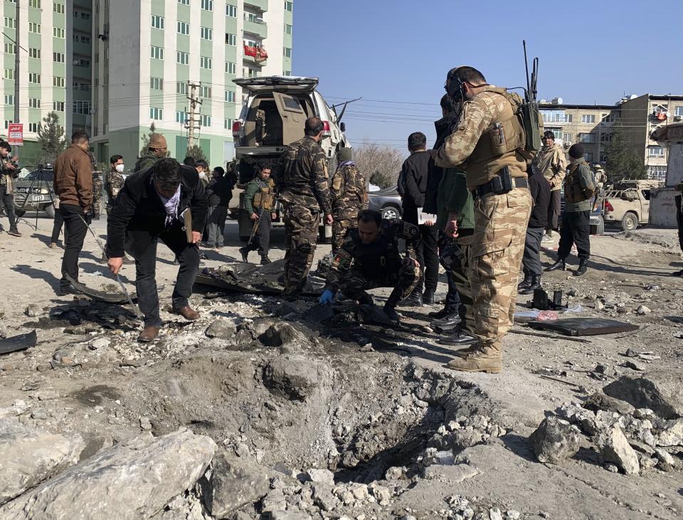 Afghan police arrive at the site of a bomb attack in Kabul, Afghanistan, Tuesday, Dec. 15, 2020. A bombing and a shooting attack on Tuesday in the Afghan capital of Kabul killed a few people, including a deputy provincial governor, officials said.(AP Photo/Rahmat Gul)