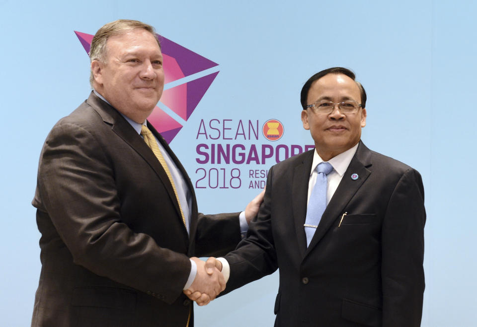 U.S. Secretary of State Mike Pompeo, left, meets Myanmar's Minister of State for Foreign Affairs U Kyaw Tin on the sidelines of the 51st ASEAN Foreign Ministers Meeting in Singapore, Saturday, Aug. 4, 2018. (AP Photo/Joseph Nair)