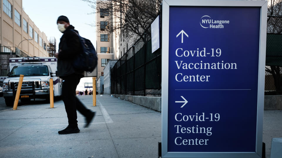 People walk by a sign for both a Covid-19 testing clinic and a Covid vaccination location outside of a Brooklyn hospital on March, 29 2021 in the Brooklyn borough of New York City. (Spencer Platt/Getty Images)