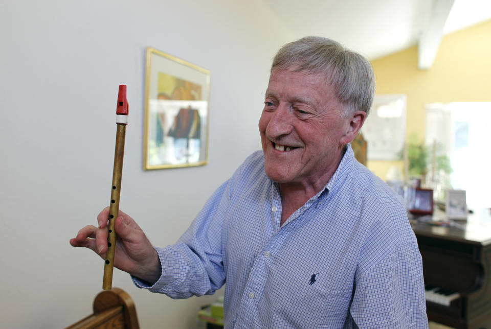 In this April 2, 2012 photo, Irish musician Paddy Moloney of the Chieftains, holds up a tin whistle at his home in Naples, Fla. Moloney collaborates with musicians, Bon Iver, the Pistol Annies, the Civil Wars, the Secret Sisters, the Carolina Chocolate Drops on The Chieftains' 50th anniversary album, "Voice of Ages." (AP Photo/Lynne Sladky)