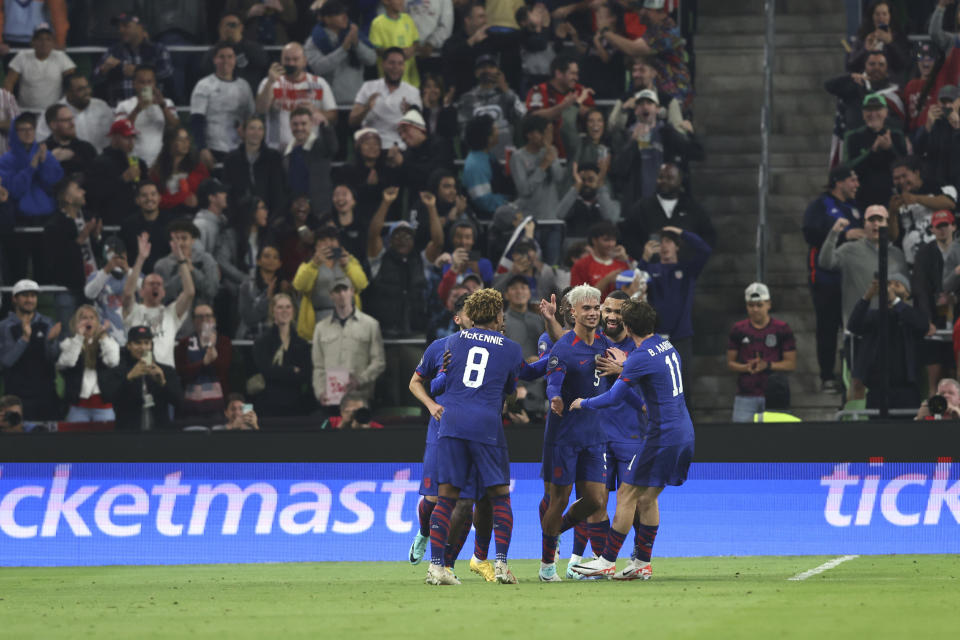 U.S. defender Antonee Robinson (5) celebrates and teammates celebrate his goal against Trinidad and Tobago during the second half of the first leg of a CONCACAF Nations League soccer quarterfinal Thursday, Nov. 16, 2023, in Austin, Texas. (AP Photo/Stephen Spillman)