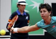 Carla Suarez Navarro of Spain returns the ball to Simona Halep of Romania during their women's semi-final match at the Rome Open tennis tournament in Rome, Italy, May 16, 2015. REUTERS/Stefano Rellandini