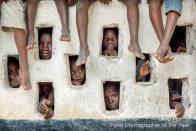 Grand Gedeh, Liberia. Children watch an Oxfam team at work. <br><br>Timothy Allen, UK<br><br>Camera: Canon 5D Mark II. <br><br>Winner, Best Single Image in a People Watching portfolio<br><br>The winner in this category receives a Giclee exhibition print from Genesis Digital Imaging, a print of an historic image from the Royal Geographical Society (with IBG) archive, and Adobe Photoshop Lightroom 4.