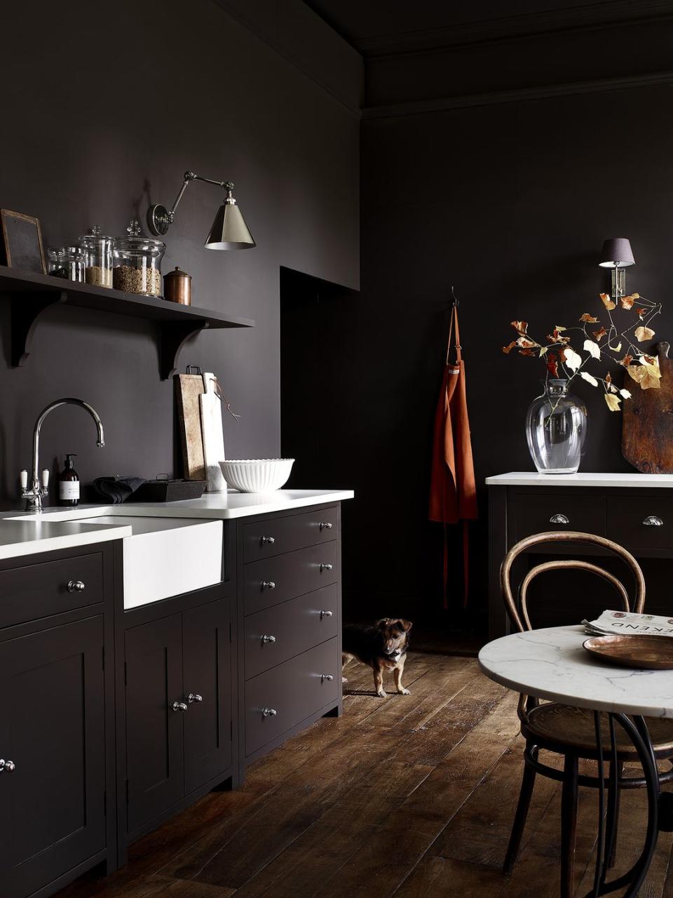 <p>By using the same paint colour on the walls, ceiling and cabinets, this kitchen feels theatrical yet sleek. Don't be afraid to embrace the darkest of shades all around your kitchen — it's a brilliant combination that will keep the guests coming back (the dog in the corner thinks so too).</p><p><strong>READ MORE: </strong><a href="https://www.housebeautiful.com/uk/lifestyle/property/a21726908/detached-house-for-sale-sussex-tennis-court-gardens/" rel="nofollow noopener" target="_blank" data-ylk="slk:Beautiful detached house comes with tennis courts and lush gardens;elm:context_link;itc:0;sec:content-canvas" class="link ">Beautiful detached house comes with tennis courts and lush gardens </a></p><p>• Shop the look at <a href="https://www.neptune.com/" rel="nofollow noopener" target="_blank" data-ylk="slk:Neptune;elm:context_link;itc:0;sec:content-canvas" class="link ">Neptune</a></p>