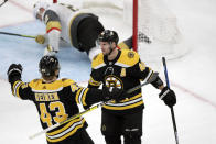 Boston Bruins center David Krejci (46) is congratulated by center Danton Heinen (43) after scoring on Vegas Golden Knights defenseman Nick Holden, in net, during the third period of an NHL hockey game in Boston, Tuesday, Jan. 21, 2020. (AP Photo/Charles Krupa)