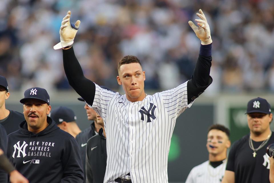The New York Yankees' Aaron Judge celebrates after hitting a walk-off single in the bottom of the ninth inning to beat the Tampa Bay Rays and clinch berth in AL wild-card game.