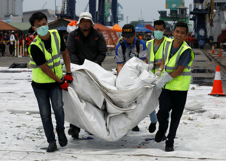 Rescue workers load up recovered debris of Lion Air flight JT610 onto a truck at Tanjung Priok port in Jakarta, Indonesia, November 2, 2018. REUTERS/Edgar Su