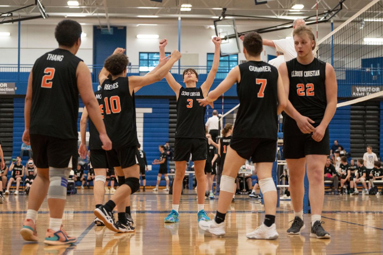 Calhoun Christian/Harper Creek co-op players celebrate a point during a game at Harper Creek on Wednesday, May 3, 2023.