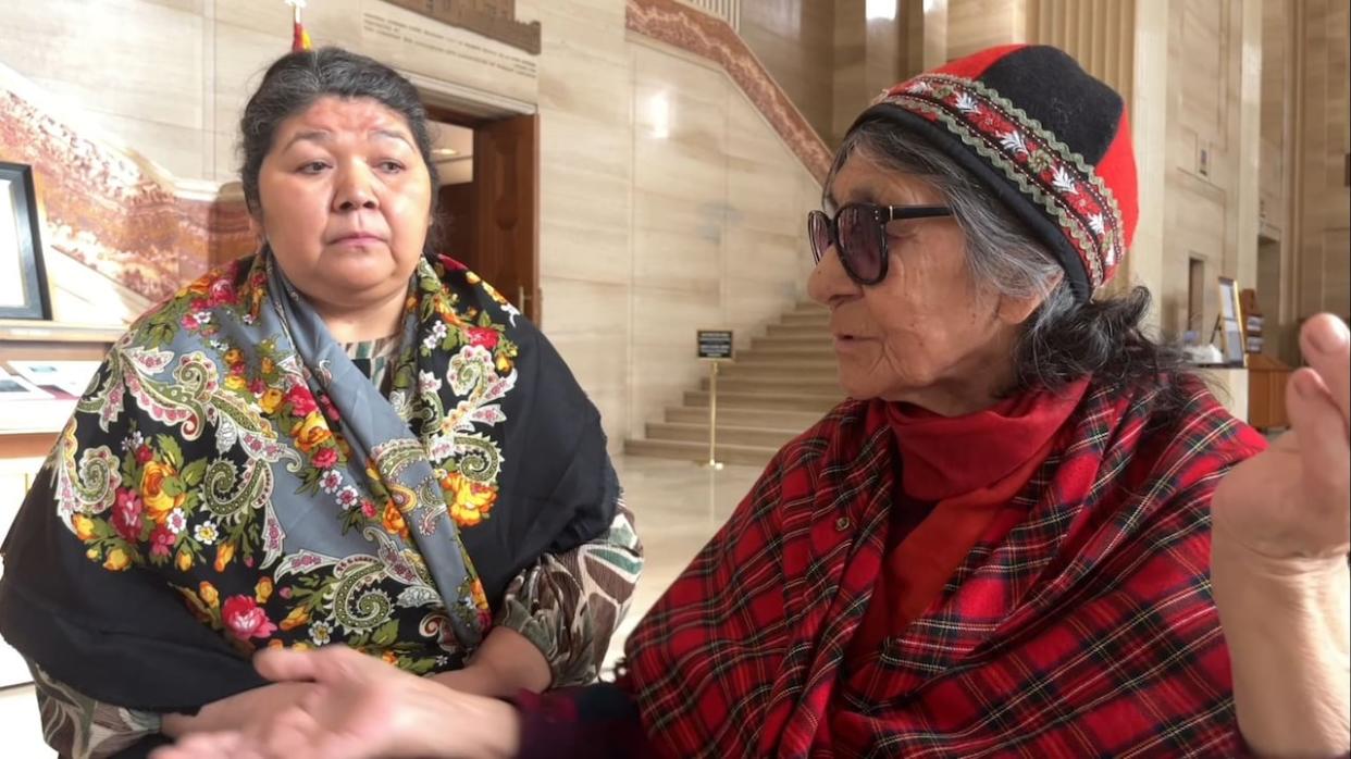 Elizabeth (Tshaukuesh) Penashue, right, speaks in Innu outside the federal courtroom in the Supreme Court of Canada building in Ottawa as Anastasia Qupee interprets. (Brett Forester/CBC - image credit)