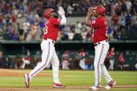 Texas Rangers' Adolis Garcia, left, and third base coach Tony Beasley, right, celebrate after Garcia hit a solo home run in the sixth inning of a baseball game against the Washington Nationals, Friday, June 24, 2022, in Arlington, Texas. (AP Photo/Tony Gutierrez)