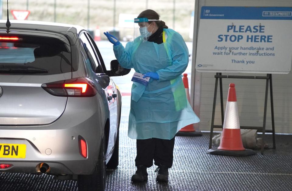 A swab test is performed at a drive-through centre  (PA Wire)