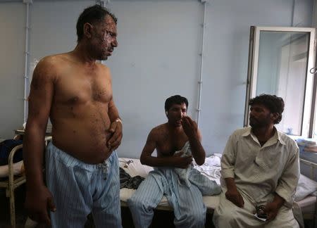 Wounded Afghan policemen sit in a police hospital bed in Kabul August 27, 2014. Picture taken August 27, 2014. REUTERS/Omar Sobhani
