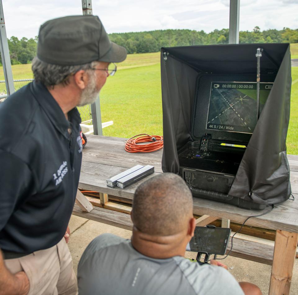 Drone instructor Joseph Dorando with Wounded Eagle UAS watches as student Terry Wallace takes flight Monday at the Escambia RC Model Park. Wallace is taking part in a program that teaches wounded and disabled veterans how to operate and repair drones, as well as earn an FAA or commercial drone driver's license.