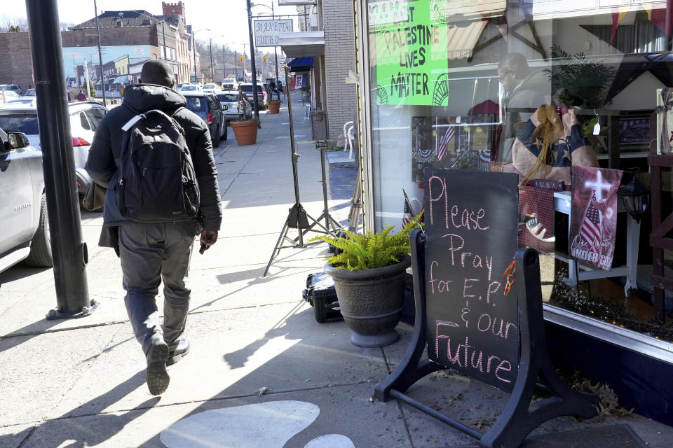 A pedestrian walks down the street in East Palestine, Ohio, as cleanup from the Feb. 3 Norfolk Southern train derailment continues, Friday, Feb. 24, 2023. (AP Photo/Matt Freed)